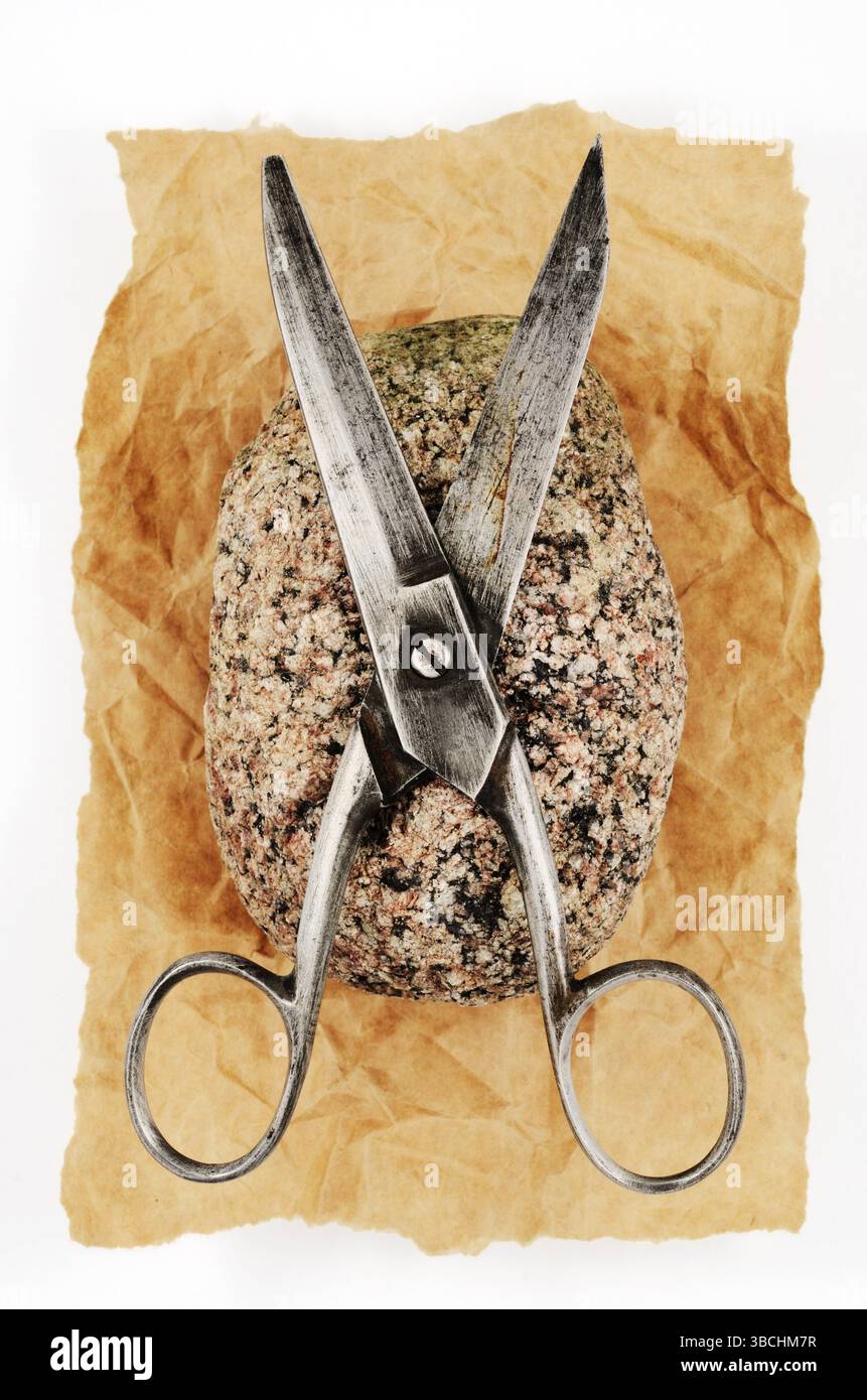Rock paper and vintage scissors, ancient game Stock Photo - Alamy