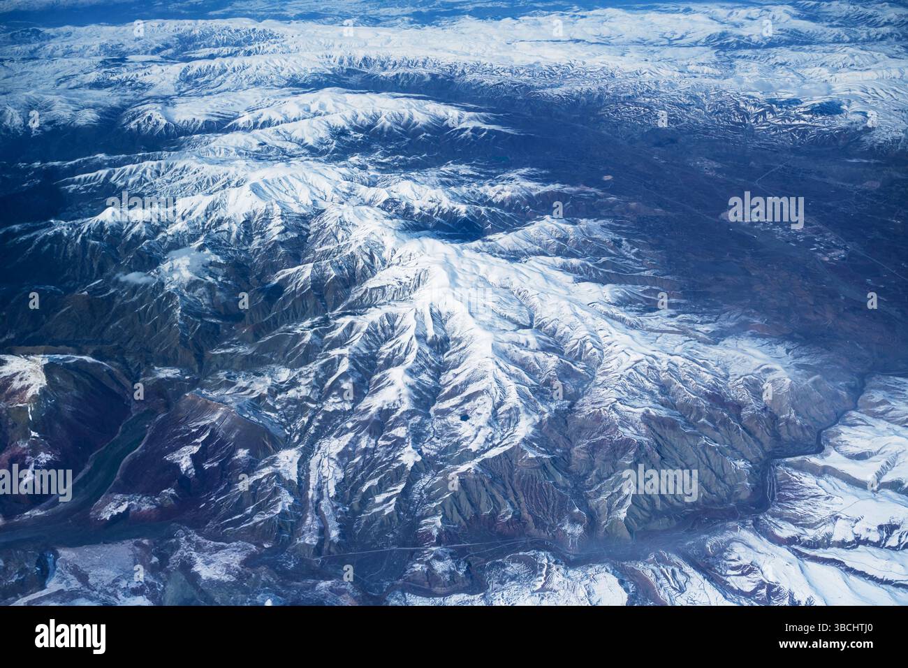 Snowy mountain range in Turkey, structure, texture and shapes, valley and river, aerial view. Stock Photo