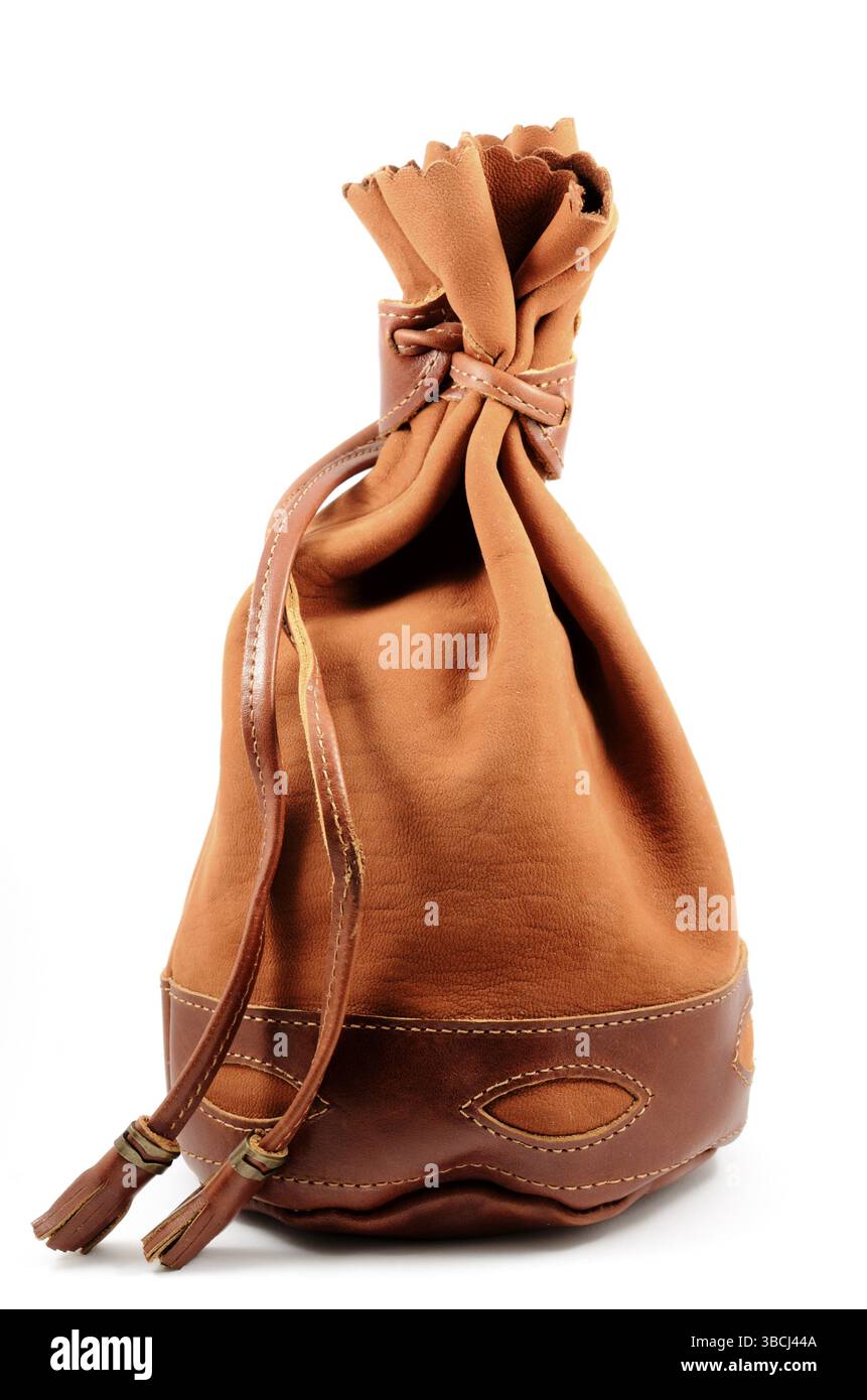 Brown suede pouch on white background, vertical Stock Photo