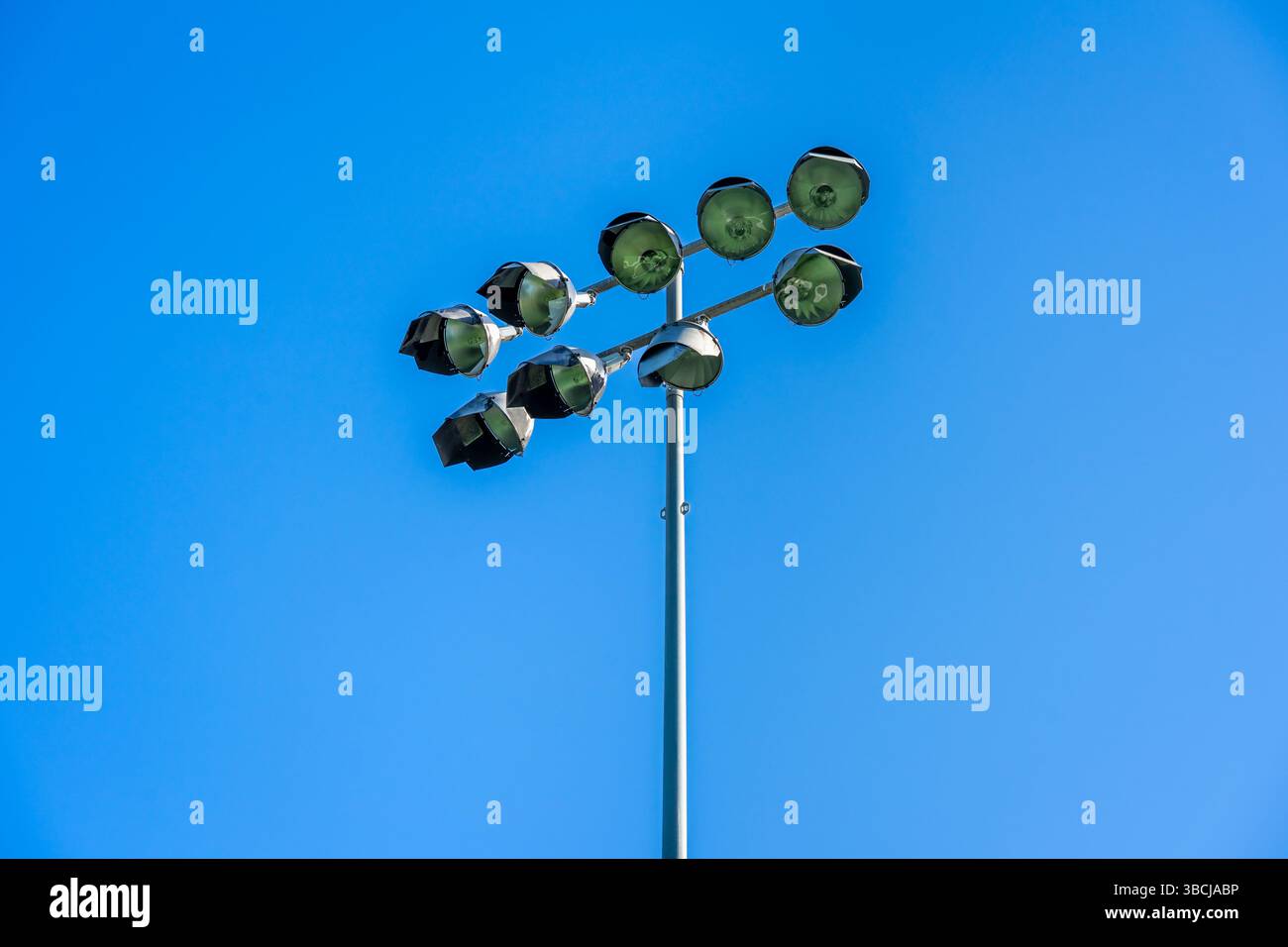 stadium floodlights on a post with a blue sky Stock Photo