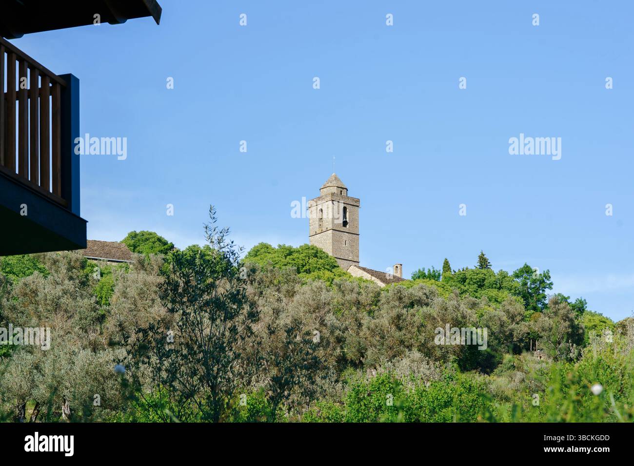 Ancient Stone Church Bell Tower Rising Above Olive Groves In Guaso Huesca, Historic Spanish Village Temple In Aragon Countryside, Medieval Religious A Stock Photo