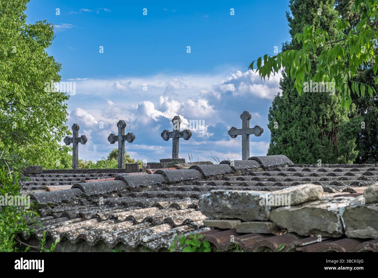 Stone Crosses On A Historic Rooftop Against A Bright Blue Sky. Religious symbolism, old church building, traditional architecture, serene atmosphere i Stock Photo