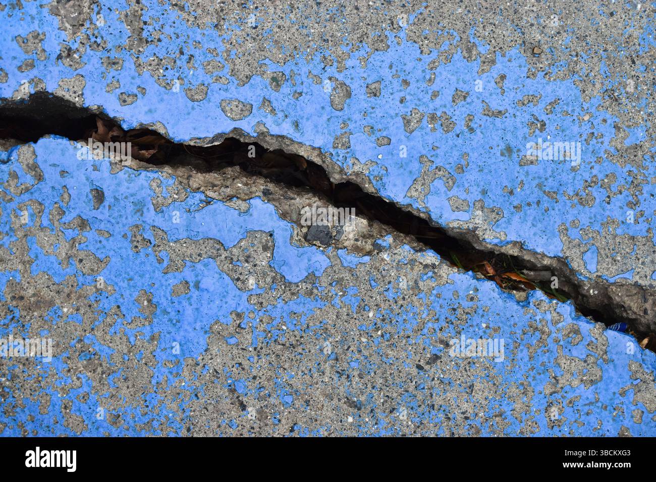 Large cracked concrete surface. Deeply cracked, broken, damaged old wall Stock Photo