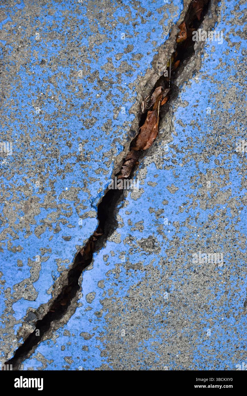 Large cracked concrete surface. Deeply cracked, broken, damaged old wall Stock Photo