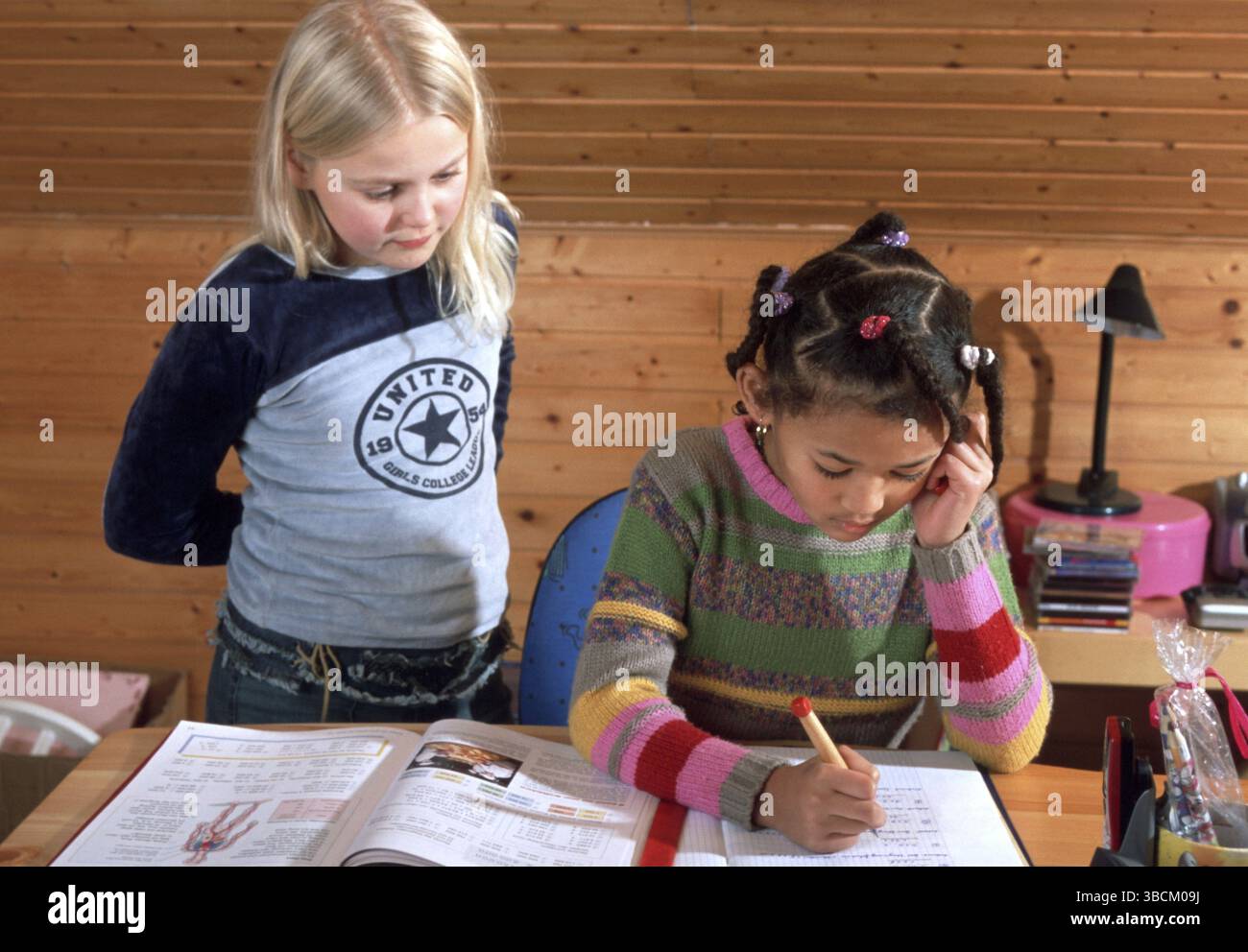 Two student, schoolgirl, do homework, compare schoolwork, learn ...