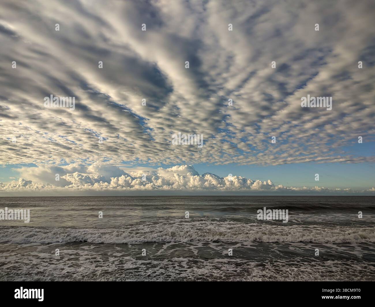 Dramatic Cloud Formation Over the Ocean with Sunlight Breaking Through Stock Photo