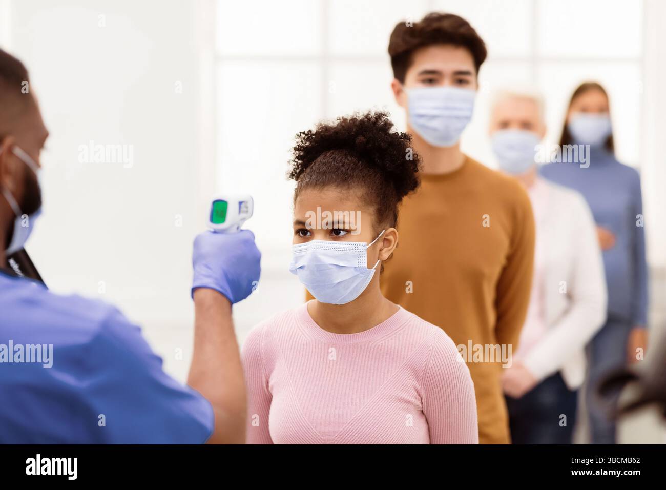 Nurses Fever Nurse Measuring Fever For Girl Standing In Queue In Hospital Stock ...