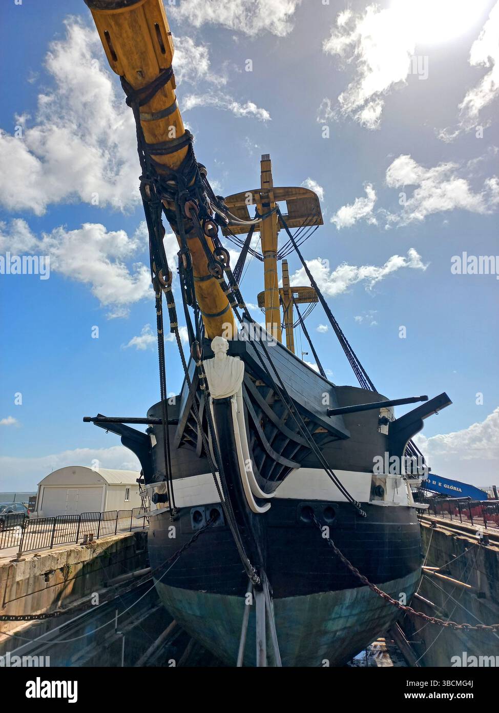 Lisbon Portugal April 19 2025 View of Dom Fernando II e Gloria frigate displayed in dry dock showing masts wooden hull and cannon deck Stock Photo