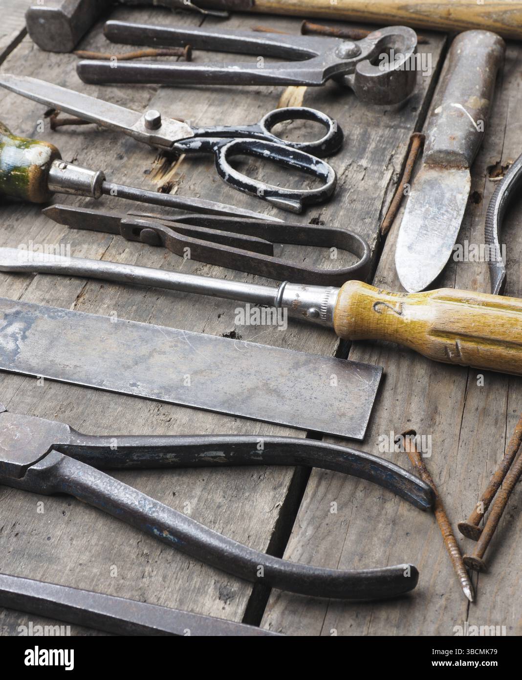 Old and rusty tools on a rustic wooden table Stock Photo