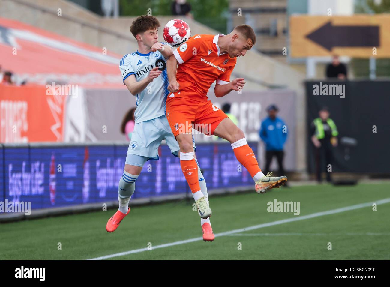 Rezart Rama (24) of Hamilton Forge FC jumps for a ball with Tom Pearce ...