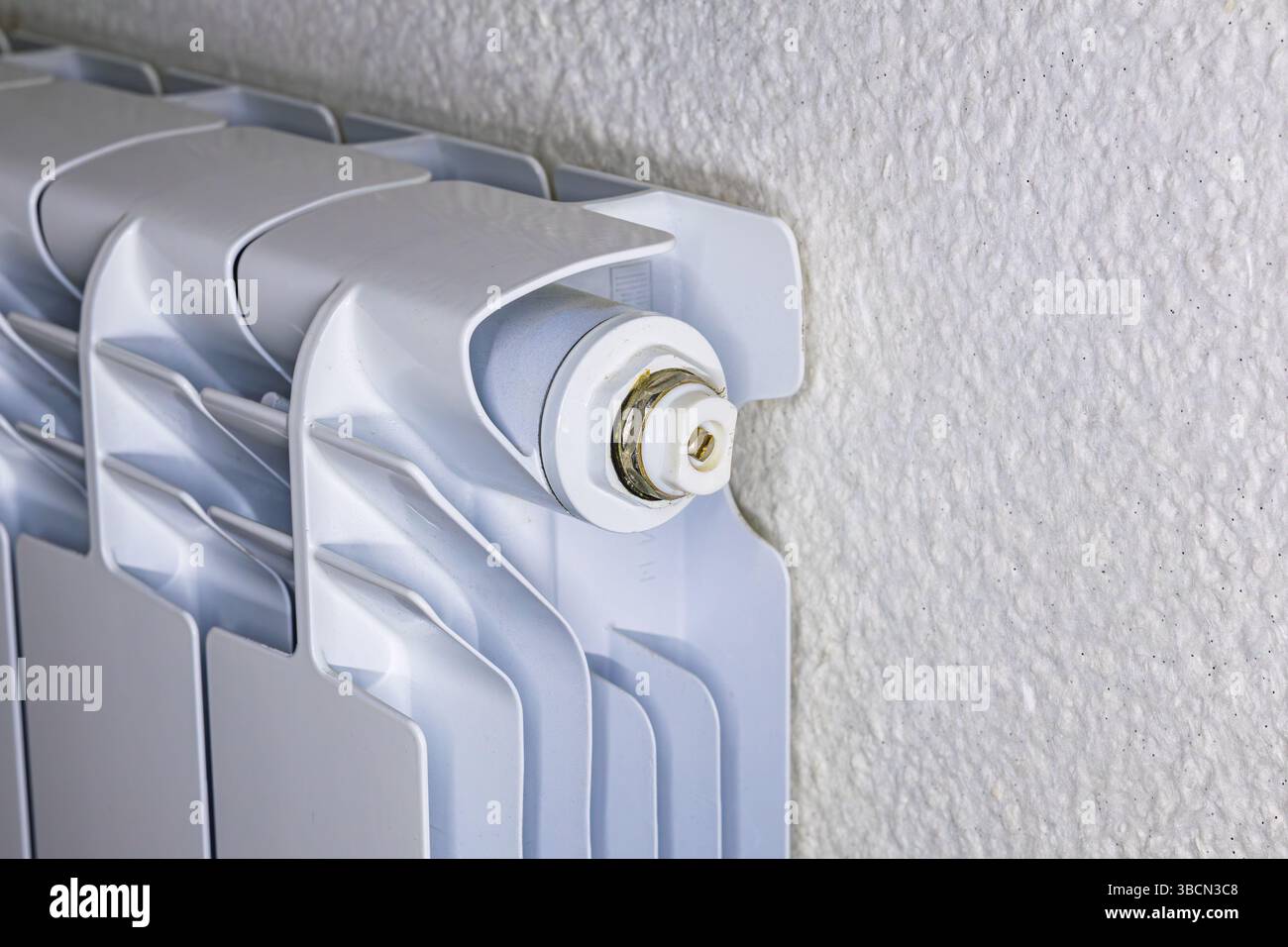 Close up of a white radiator pressure relief valve, indoor heating ...