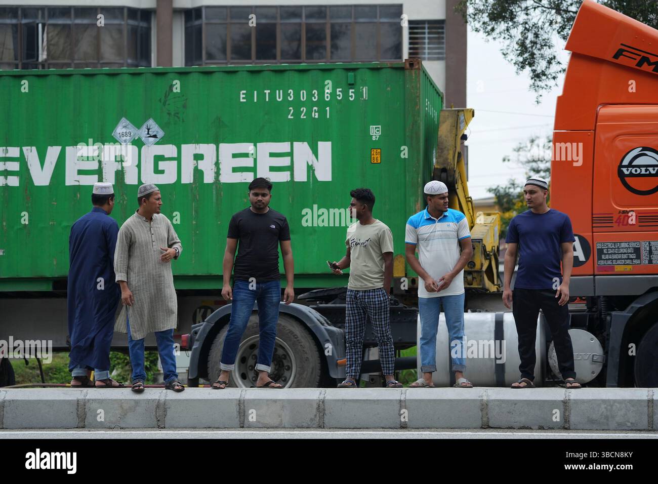 Bangladeshi migrant workers cross a road as they head to s mosque in ...