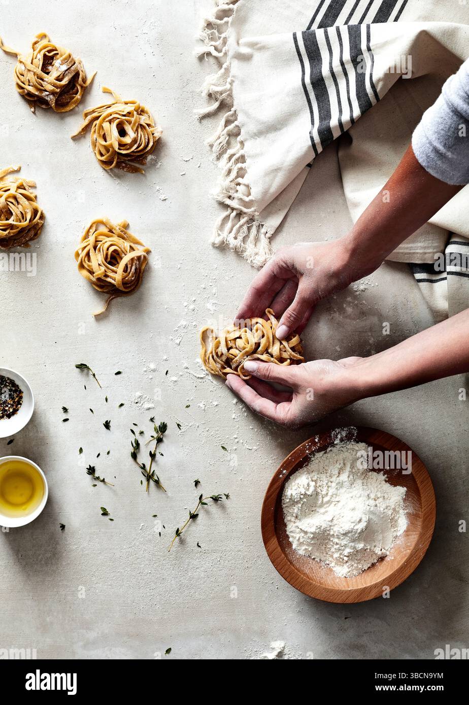 Hands shaping fresh pasta nests on floured surface with herbs Stock ... - Using Cold Hands When Shaping Pasta