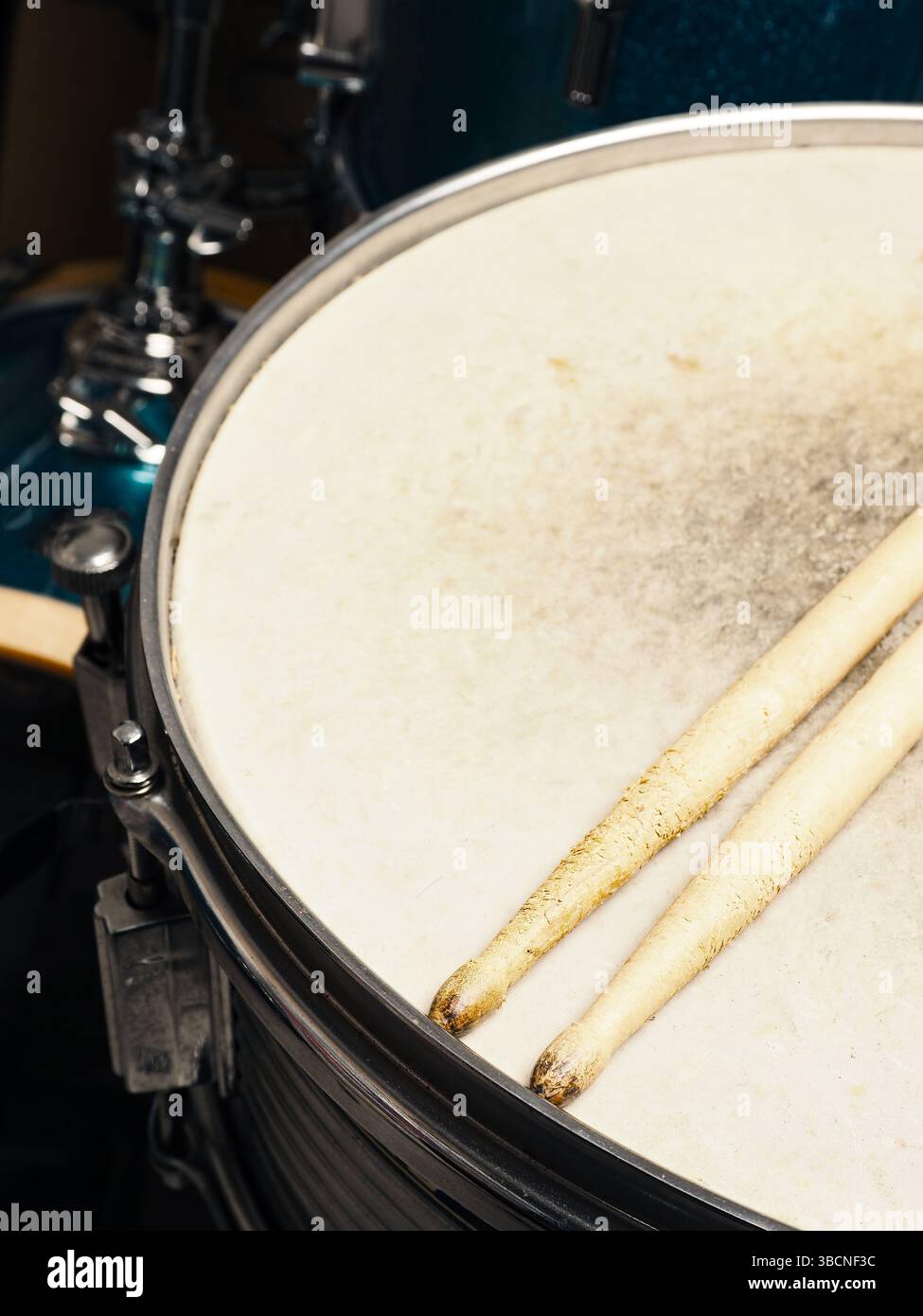 Drum sticks on a snare drum, close up shot, musician or drummer concept ...