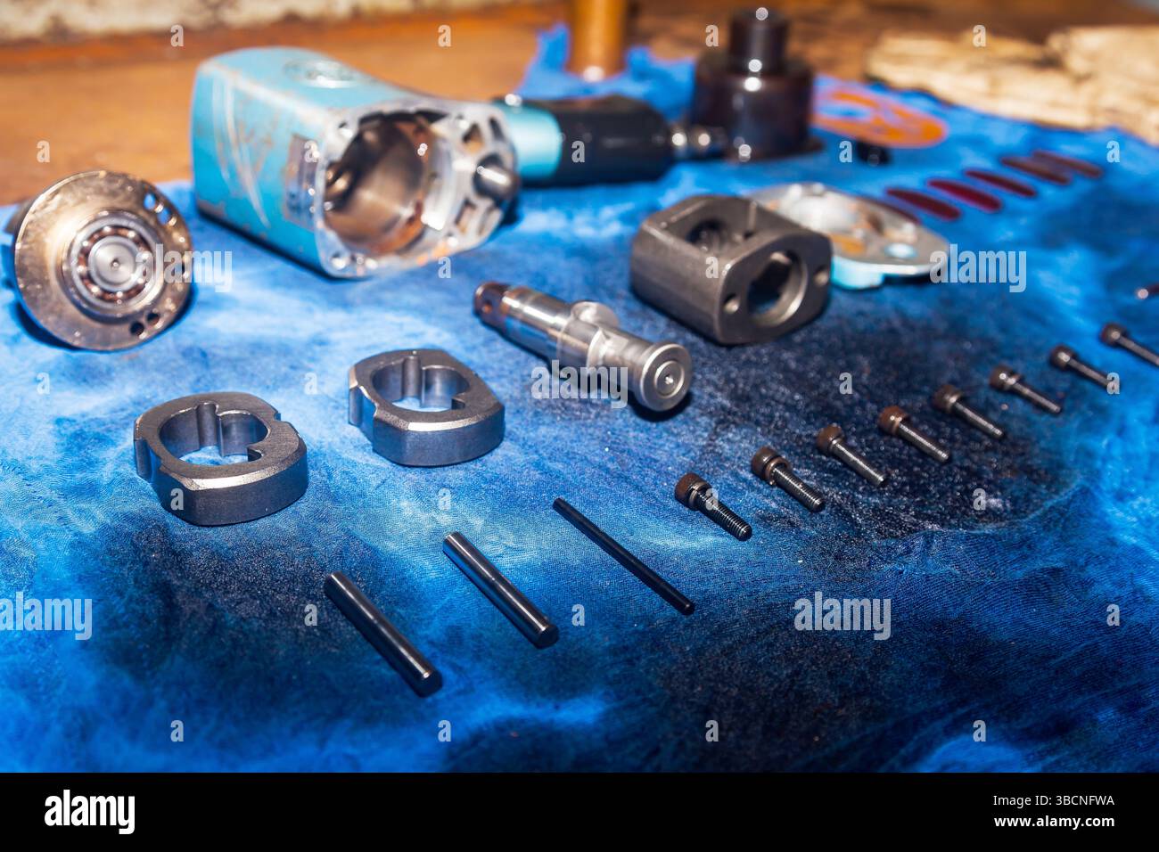 Disassembled pneumatic tool on the table. Pneumatic impact wrench. Stock Photo