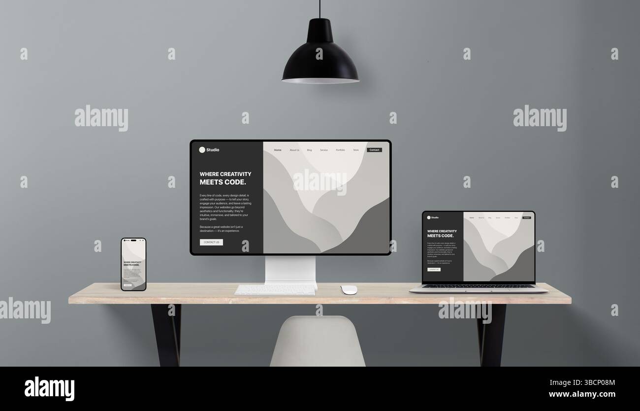 Responsive website layout shown in multiple screen formats on office desk, representing cross-device compatibility for professional web design studios Stock Photo