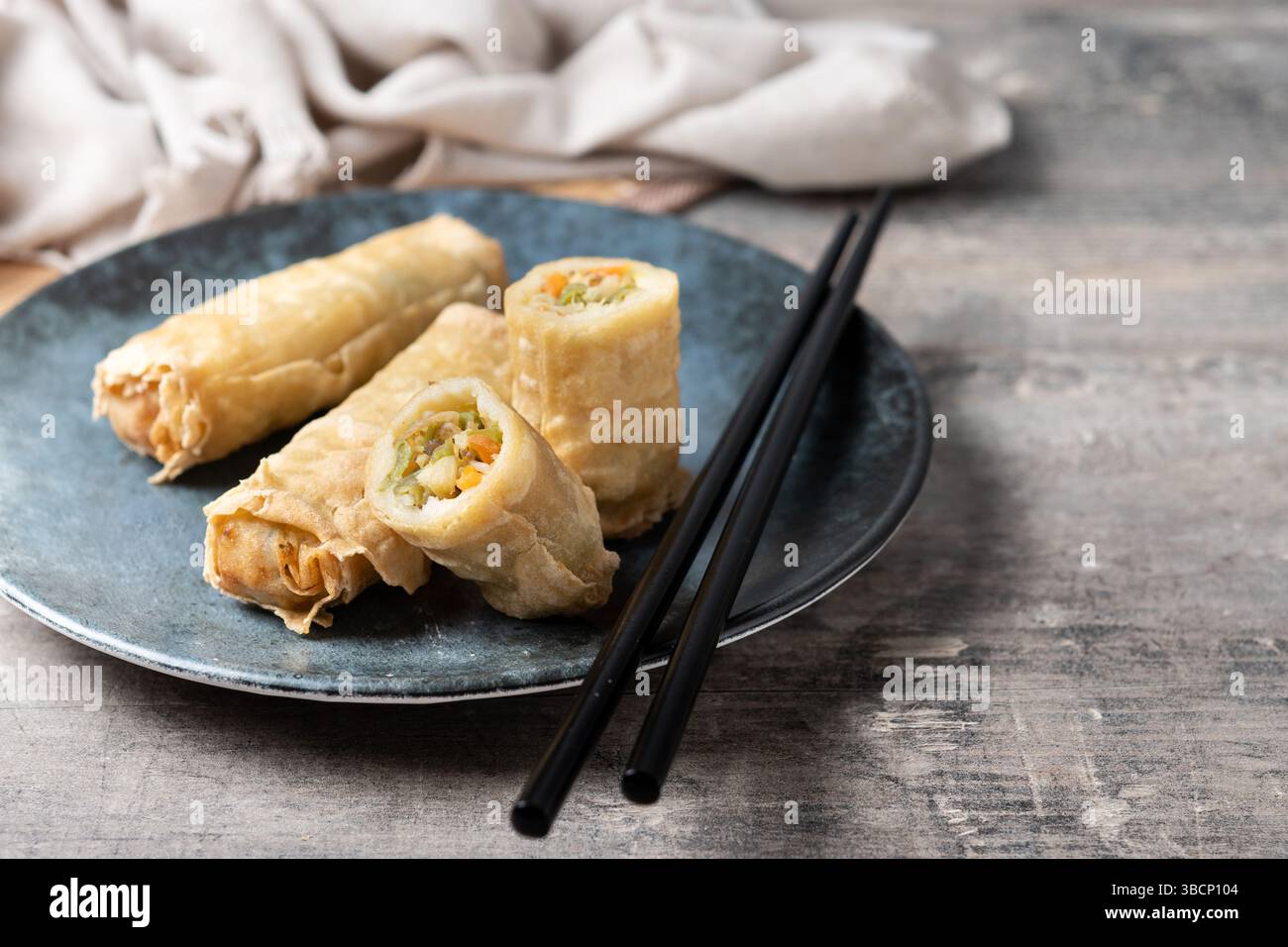 Crispy Spring Rolls on Ceramic Plate on wooden table Stock Photo