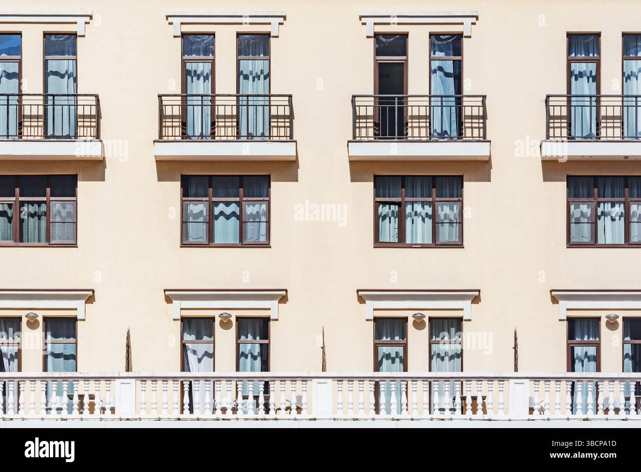 Balconies and windows of the apartment building Stock Photo - Alamy