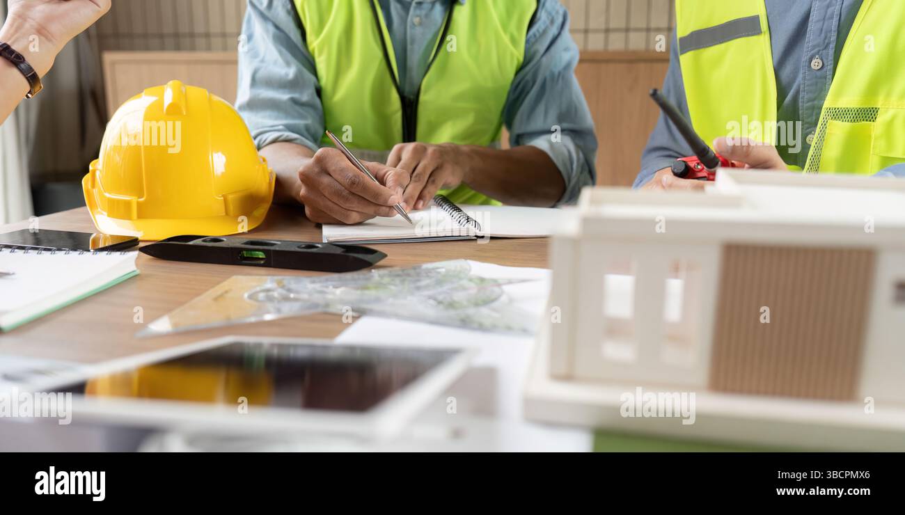 Sustainable Design Discussion. Engineers collaborating on innovative renewable energy projects in an office. Stock Photo