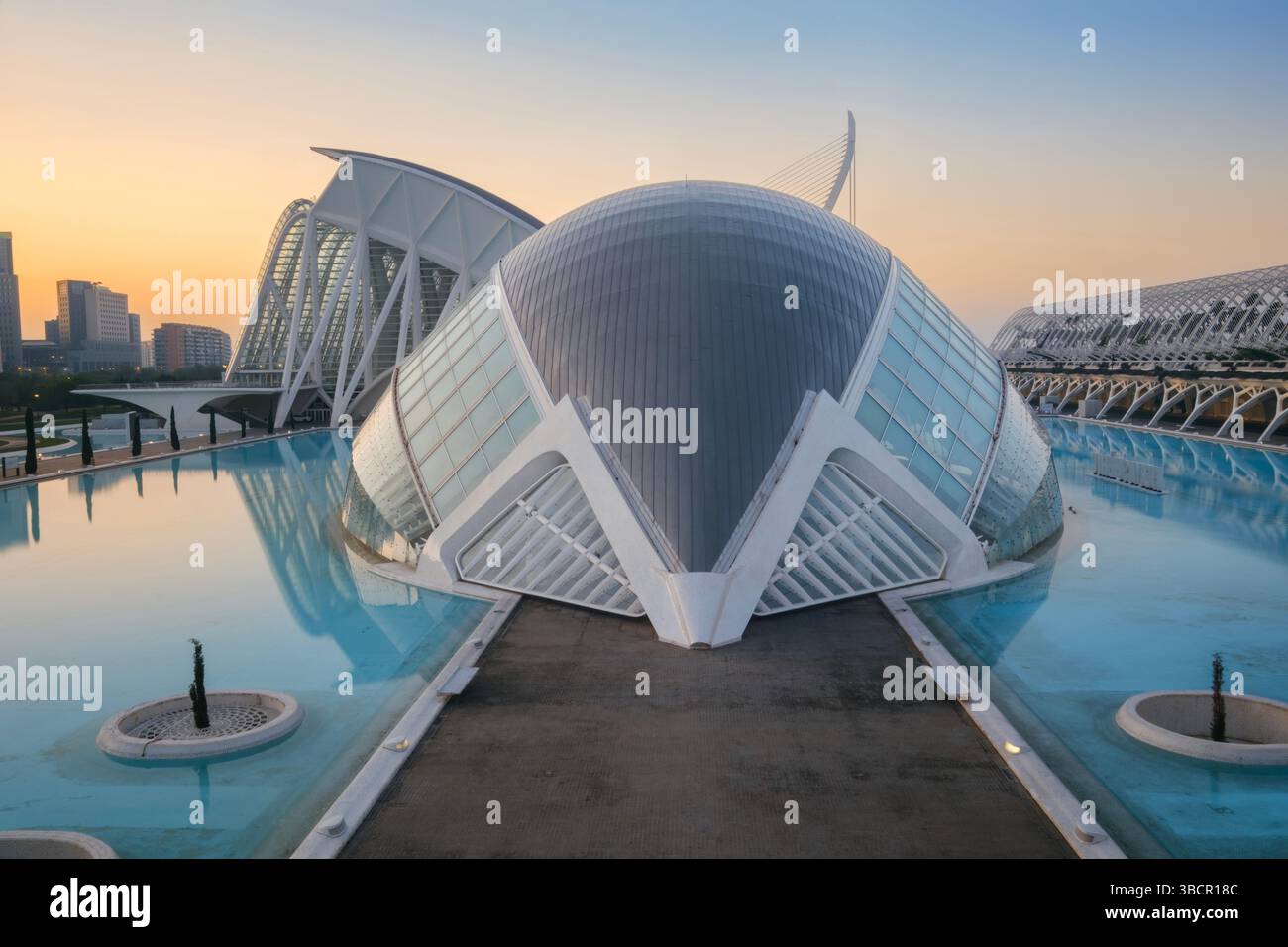 Eye of Valencia Greets the Rising Sun: Hemisferic in Glorious Morning Light. Spanish Planetarium at Daybreak, Science Center in Golden Sunrise Glow, V Stock Photo