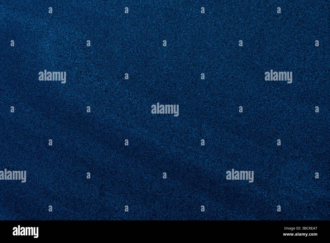 Fine-grain dark blue sand texture with subtle gradients, ideal for backgrounds and design overlays. Stock Photo