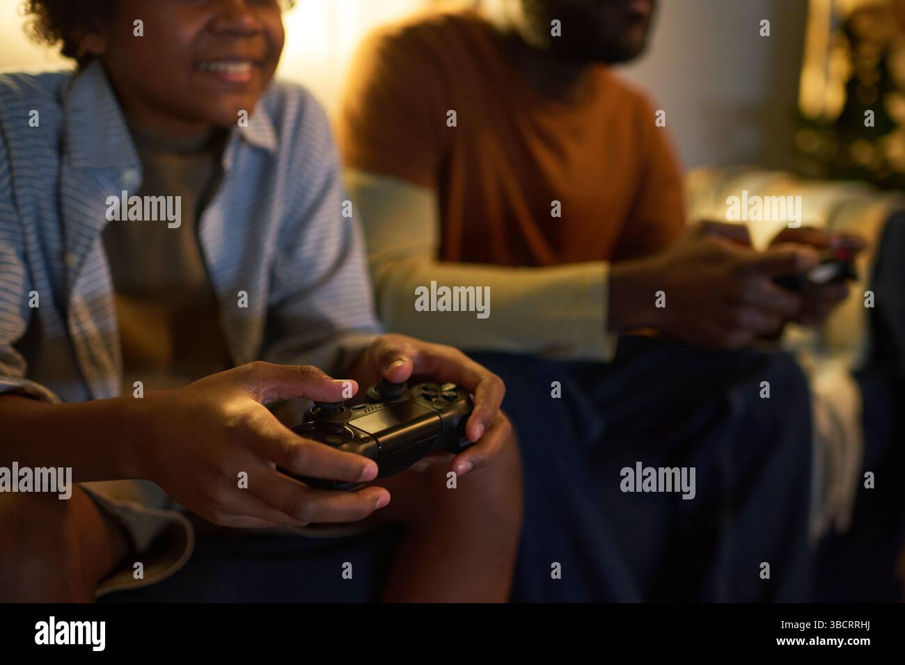 Playing Video Games Together on Couch Stock Photo