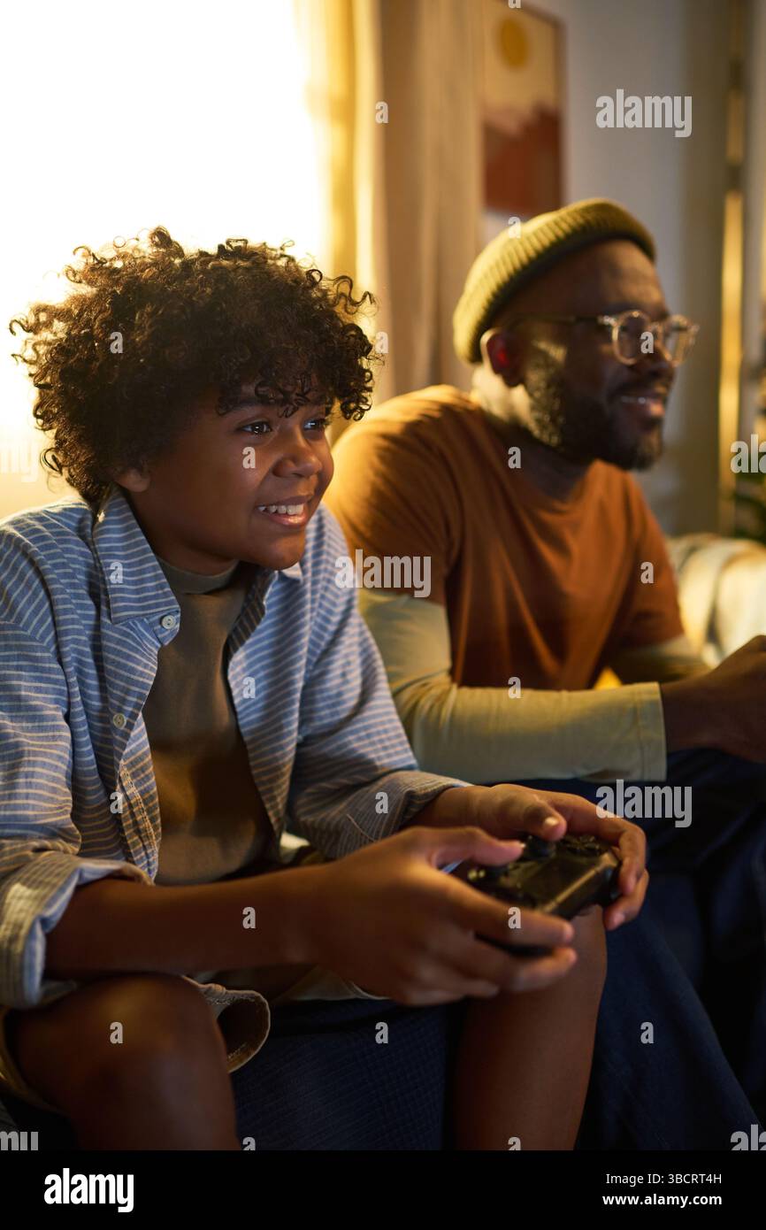 Smiling Father and Son Playing Video Games Together Stock Photo