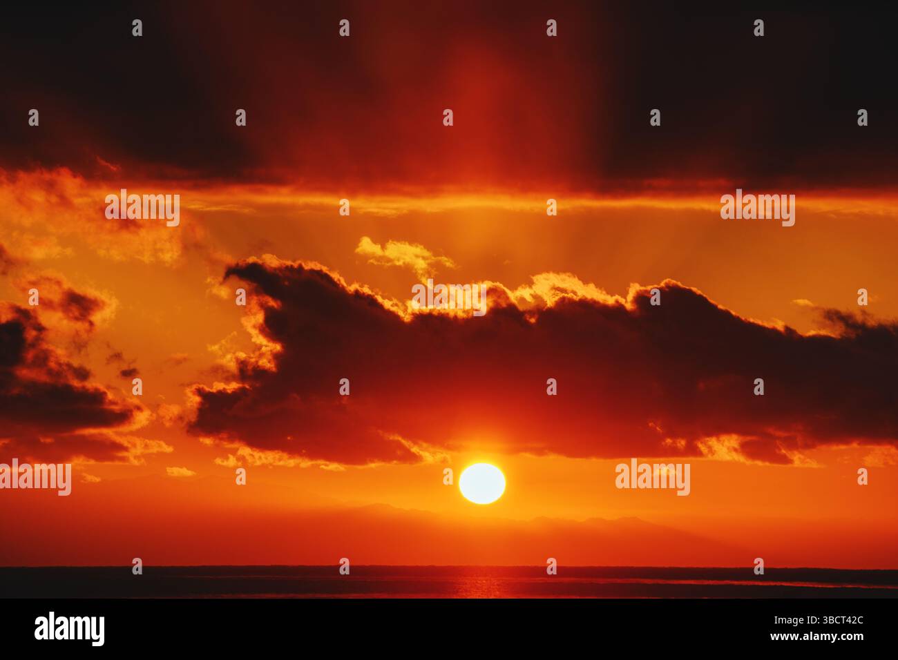 Fiery red sunset over lake Stock Photo