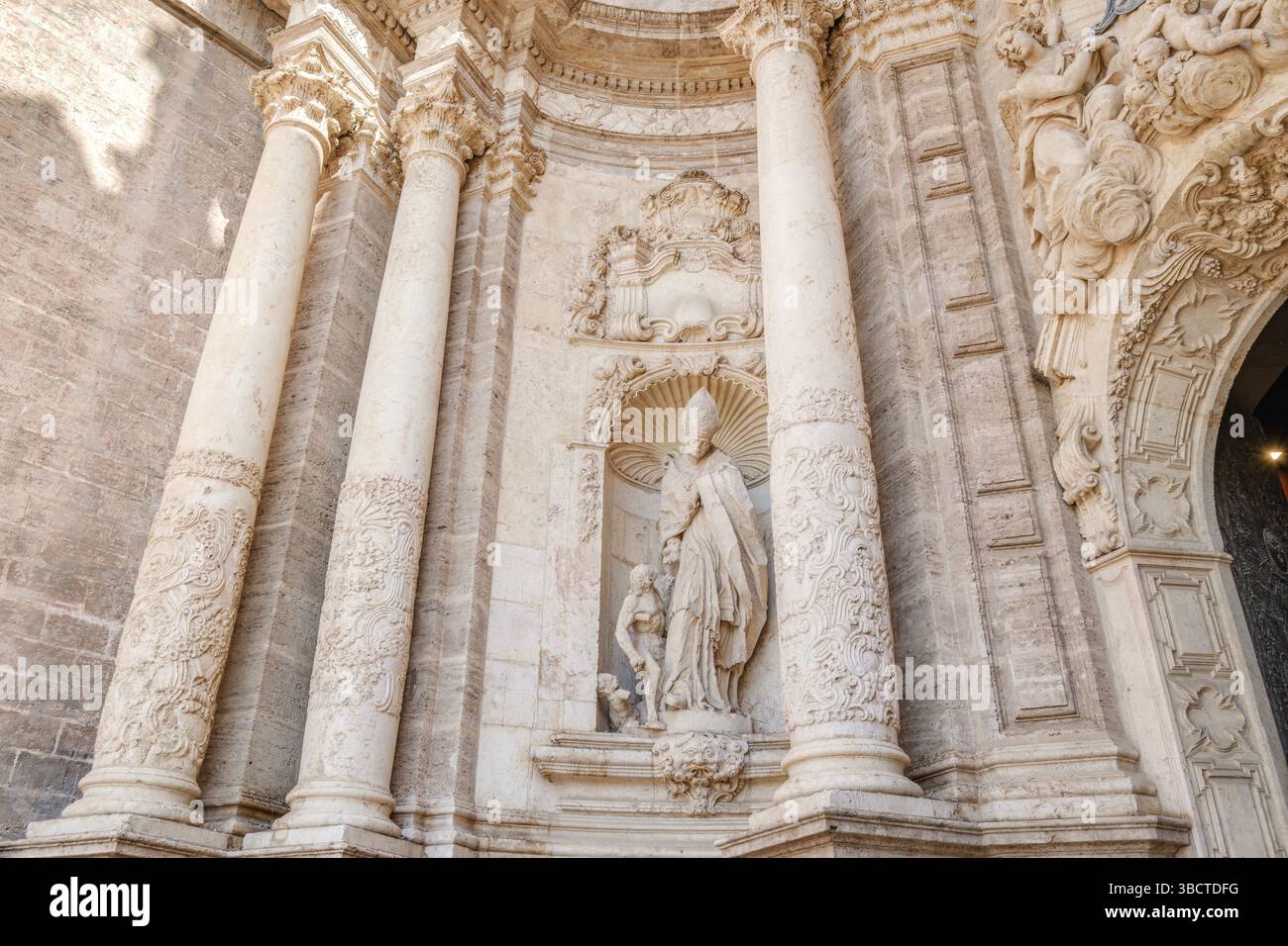 Ornate entrance of the cathedral of Valencia, showing its intricate stone carvings and historic architecture. Intricate Facade Detail Of Valencia Cath Stock Photo