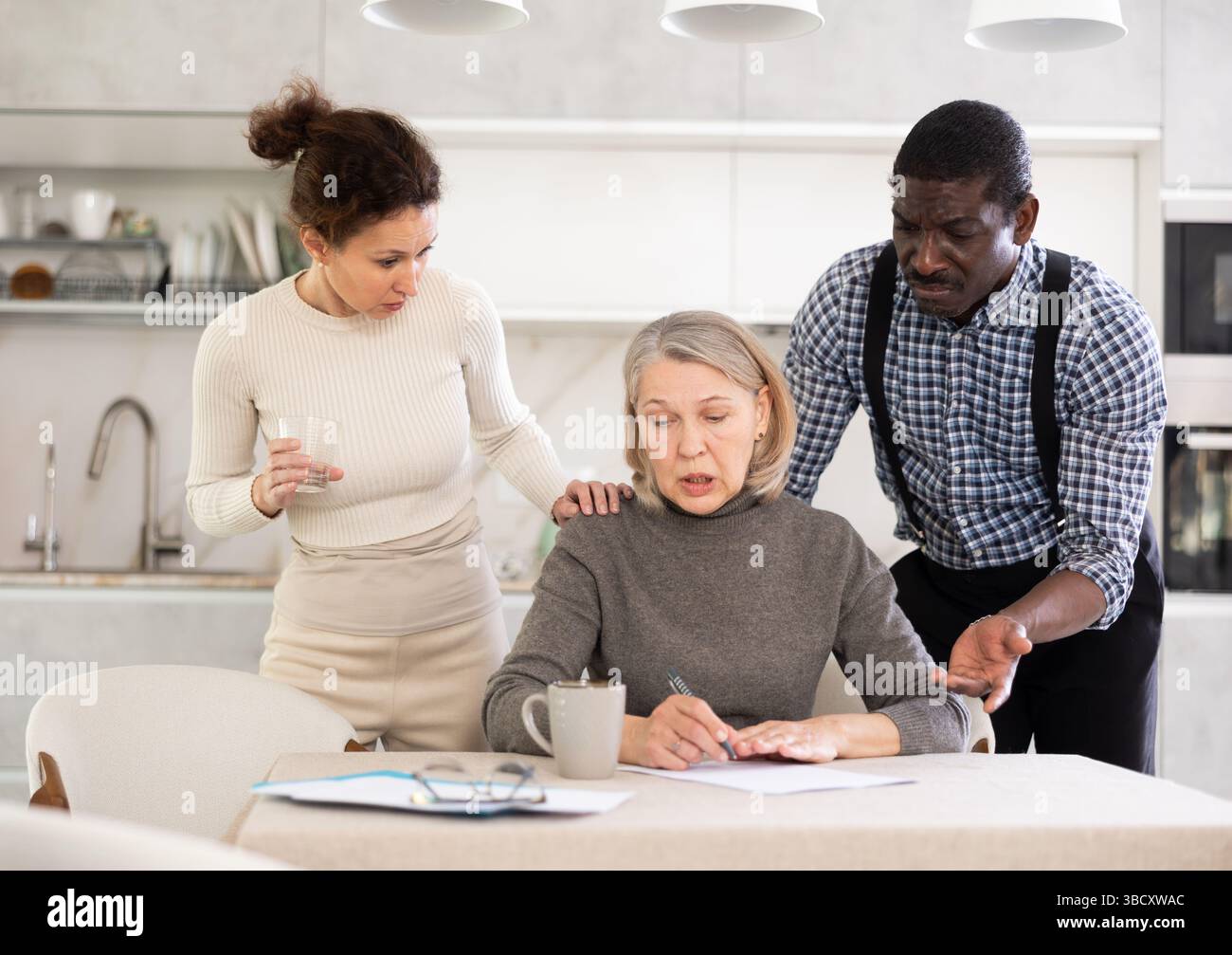 Couple discussing testament with elderly woman Stock Photo