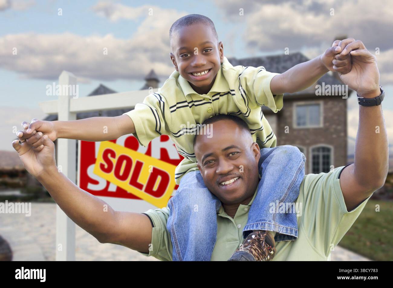 Happy african american father and son in front of new home and sold ...