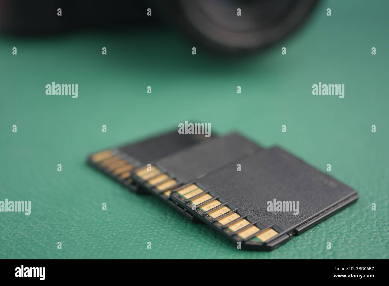 Multiple memory cards displayed on a green surface Stock Photo