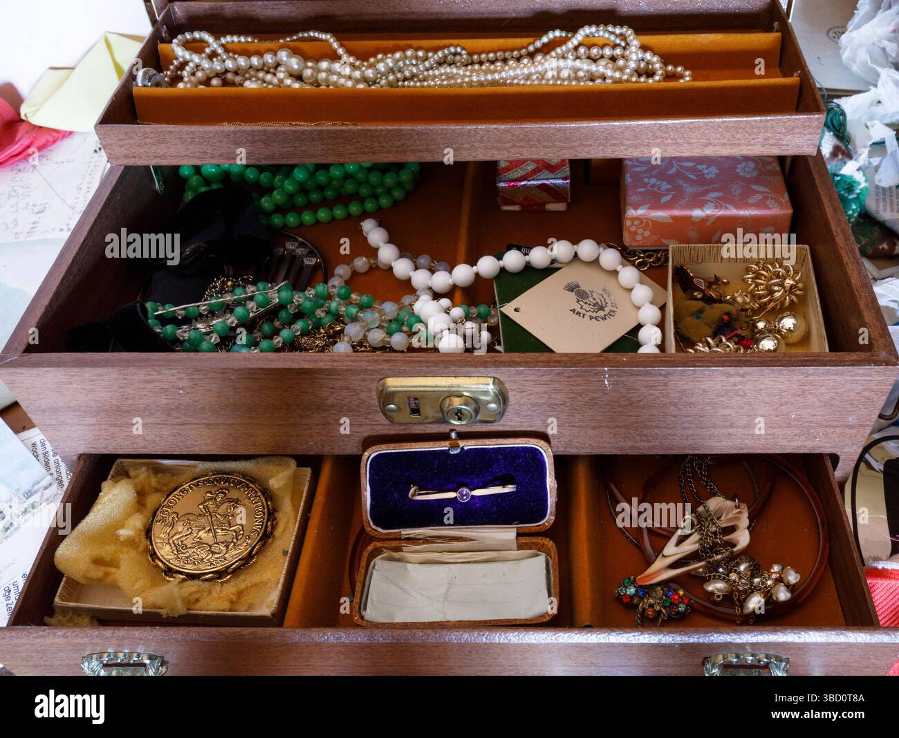 A jewelry box full of jewelry inside an abandoned house. This house has since been demolished Stock Photo