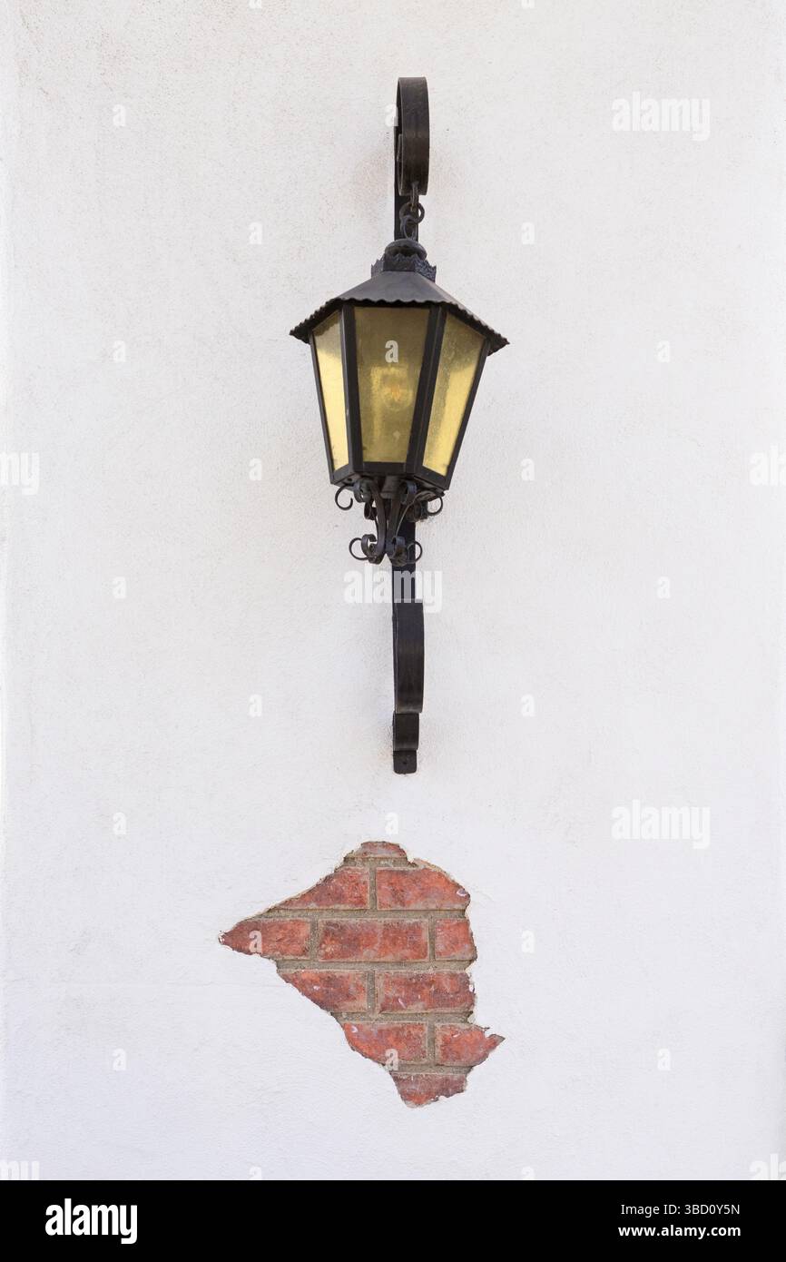 Black lamp mounted on a white wall Stock Photo