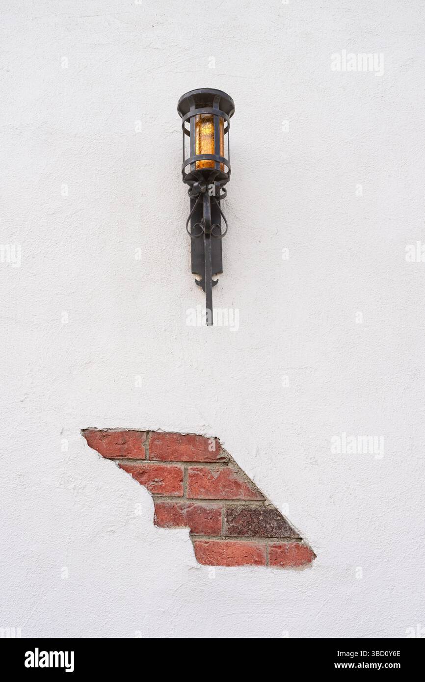 Black lamp mounted on a white wall Stock Photo