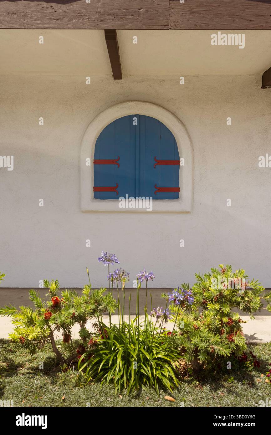 Blue boarded window on a wall Stock Photo