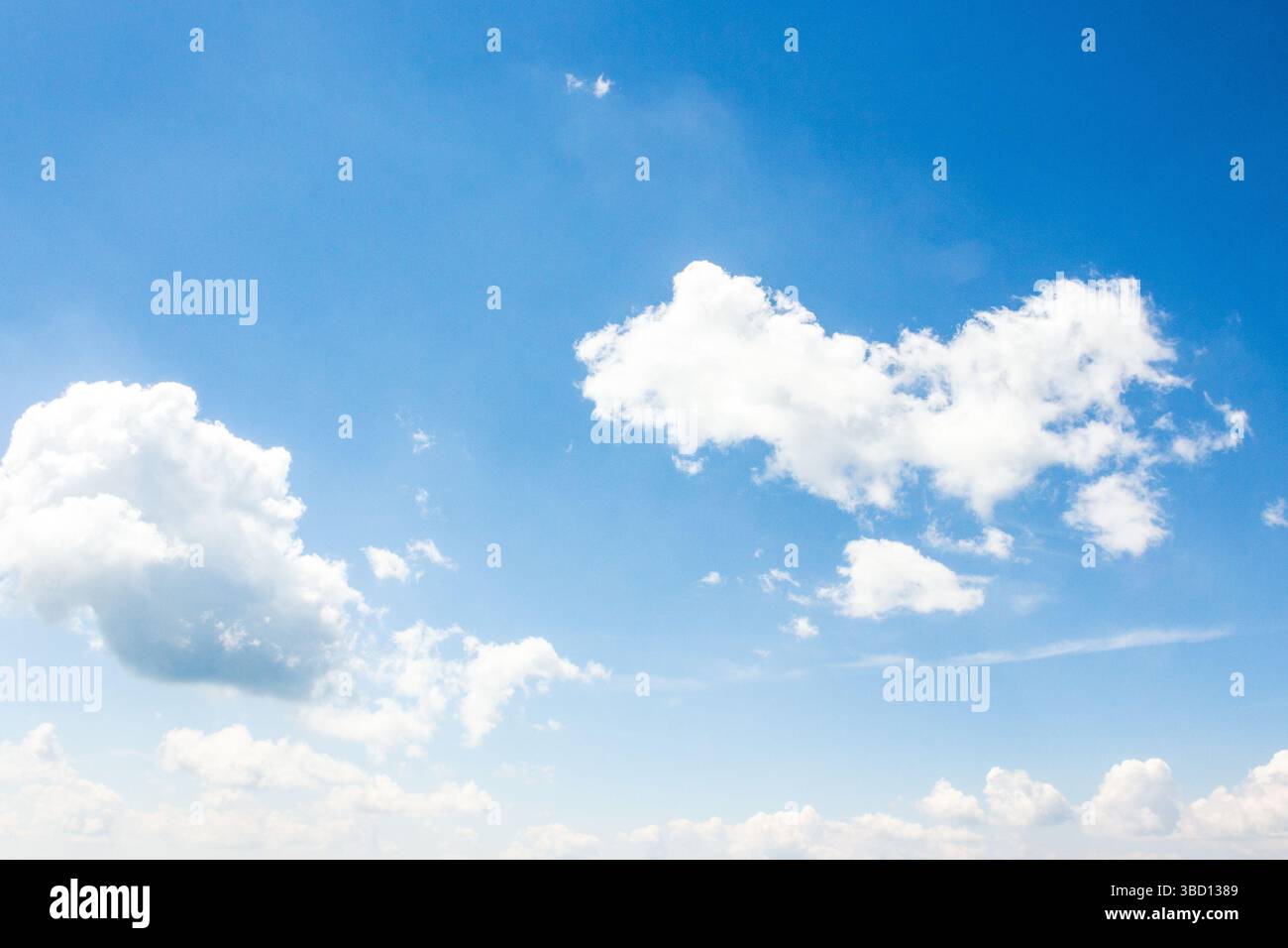 sky with fluffy clouds. azure peaceful softness.white cumulus cloudscape on a blue gradient of atmosphere. sunny summer weather. scenic nature backgro Stock Photo