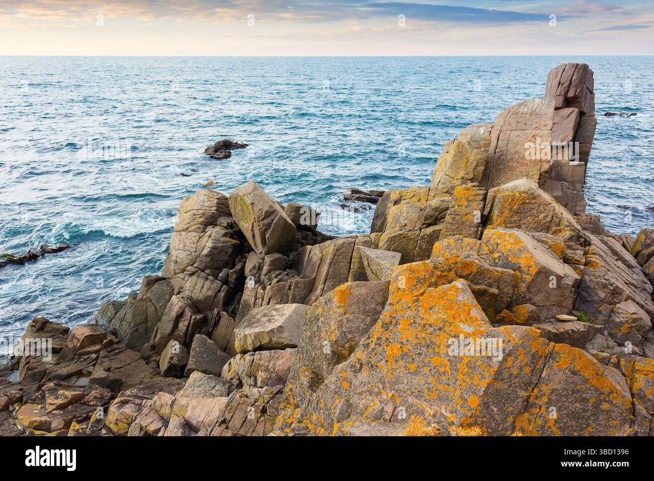 sea rock on the coast. travel nature background with stone on the shore. scenic destination. beautiful summer vacation at the seaside. calm surface of Stock Photo