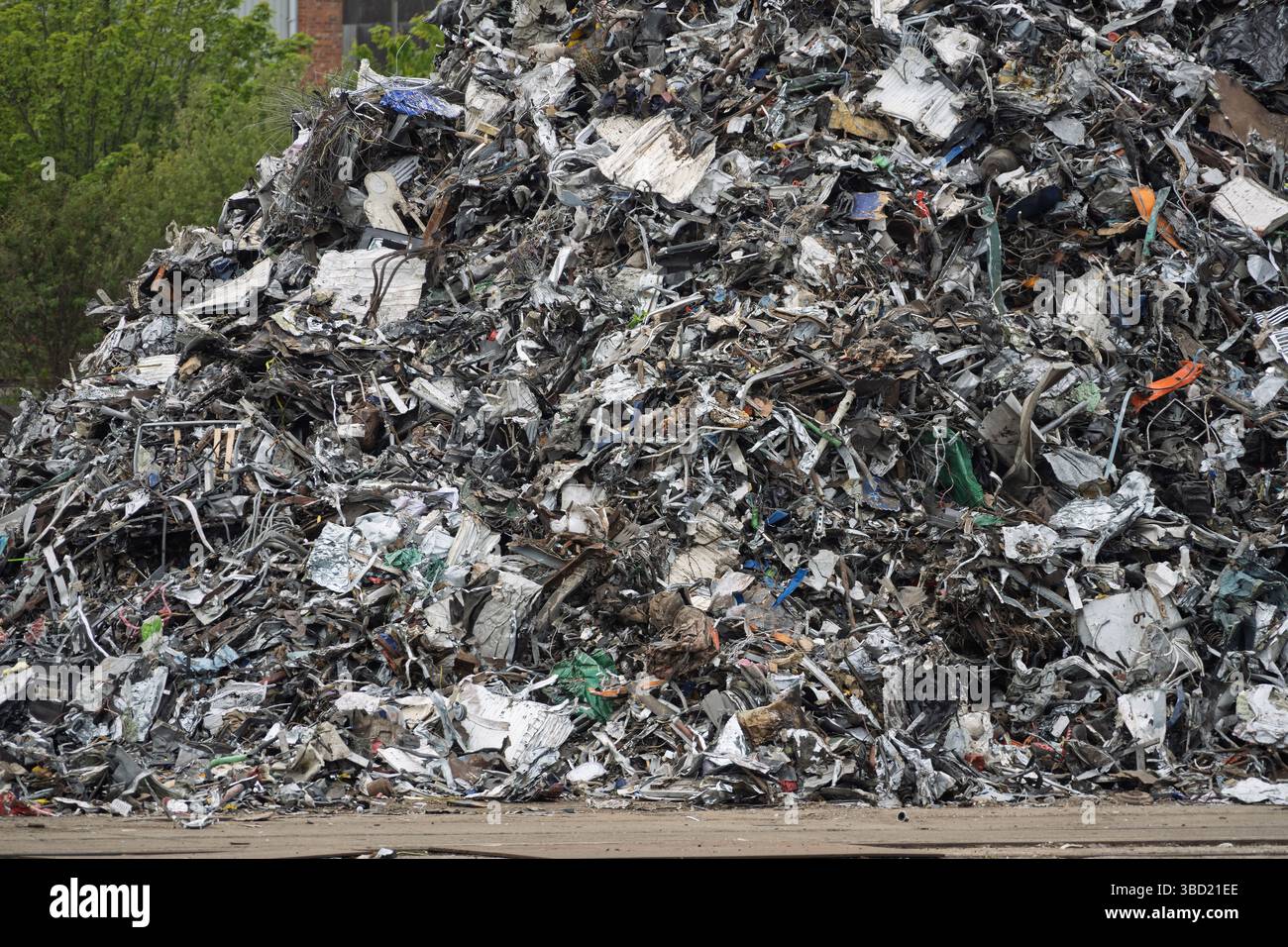 Mangled metal in a massive pile of scrap on the dockside waiting shipment for recycling. Stock Photo
