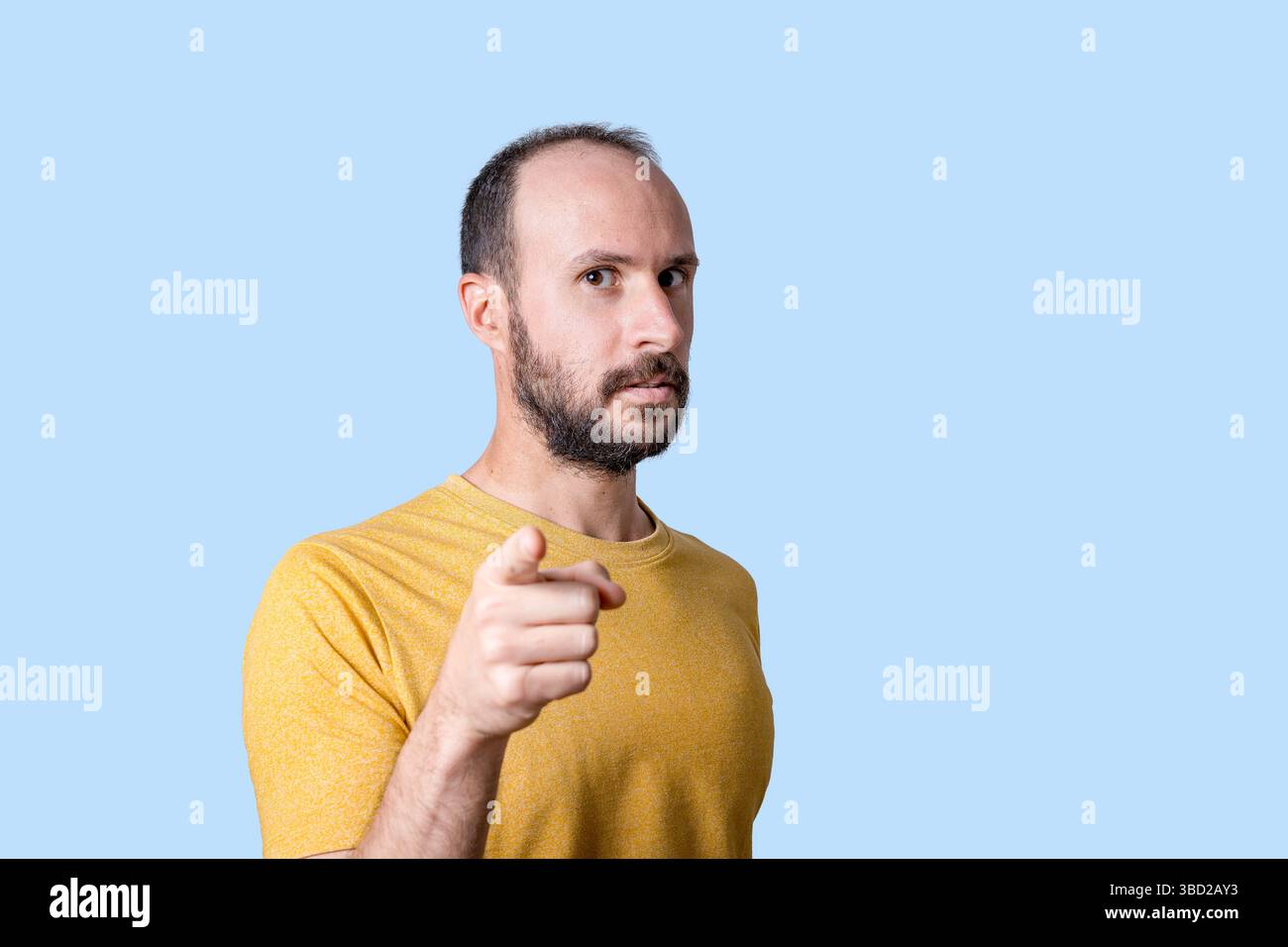 young man pointing finger at camera with serious confident expression Stock Photo