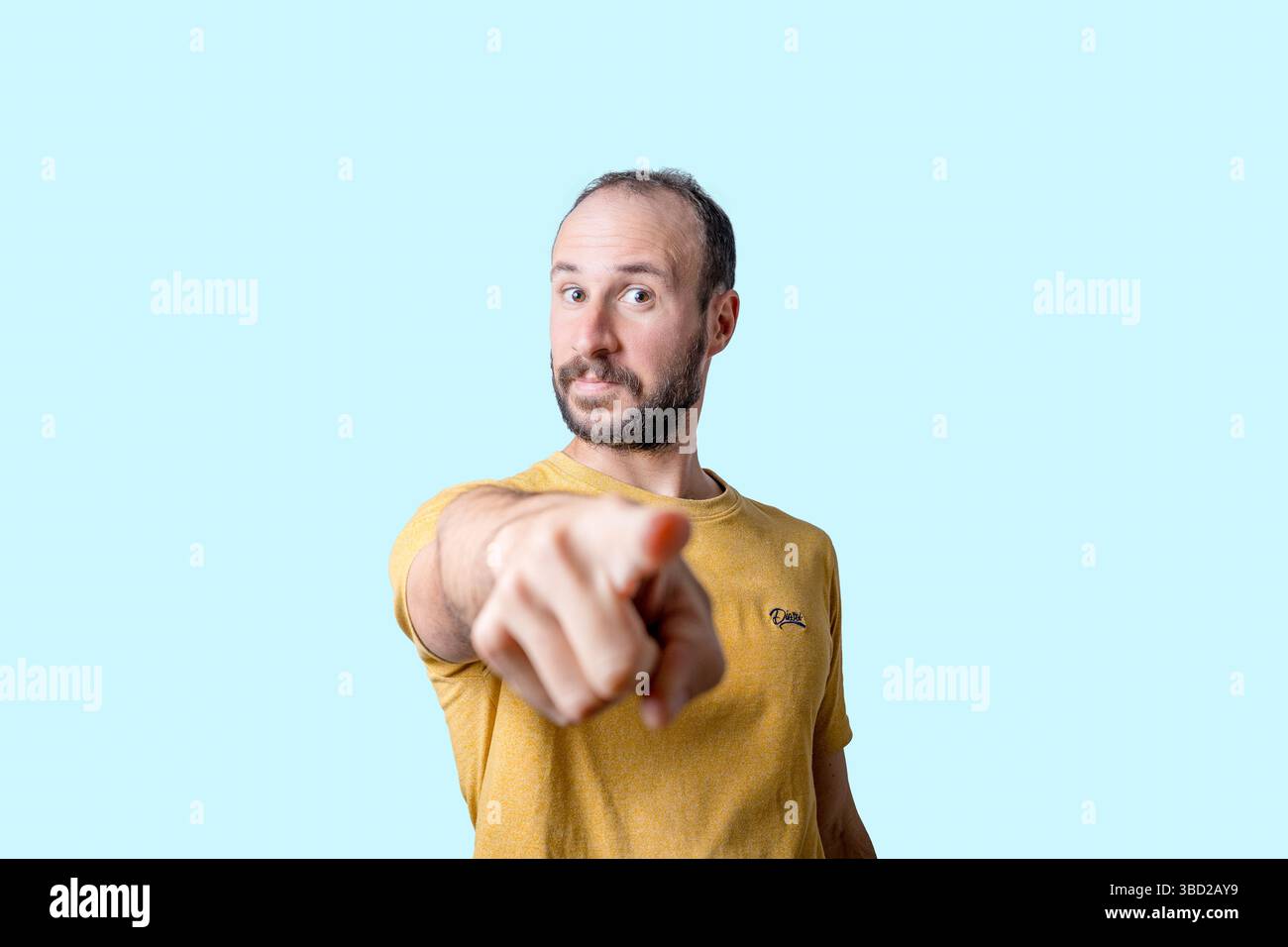 young man pointing finger at camera with serious confident expression Stock Photo