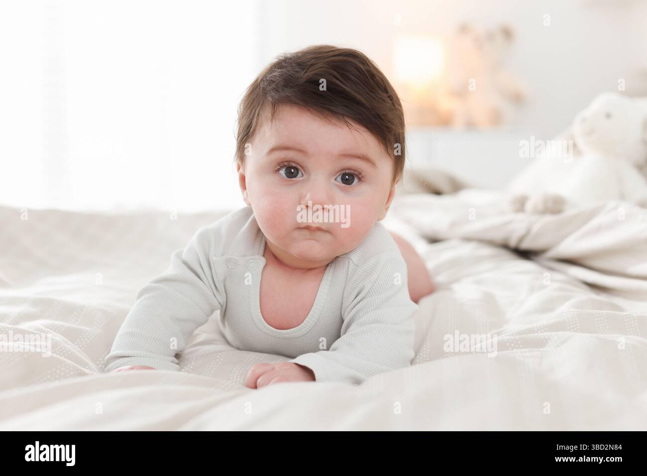 Bedtime. Cute little baby on bed at home Stock Photo - Alamy