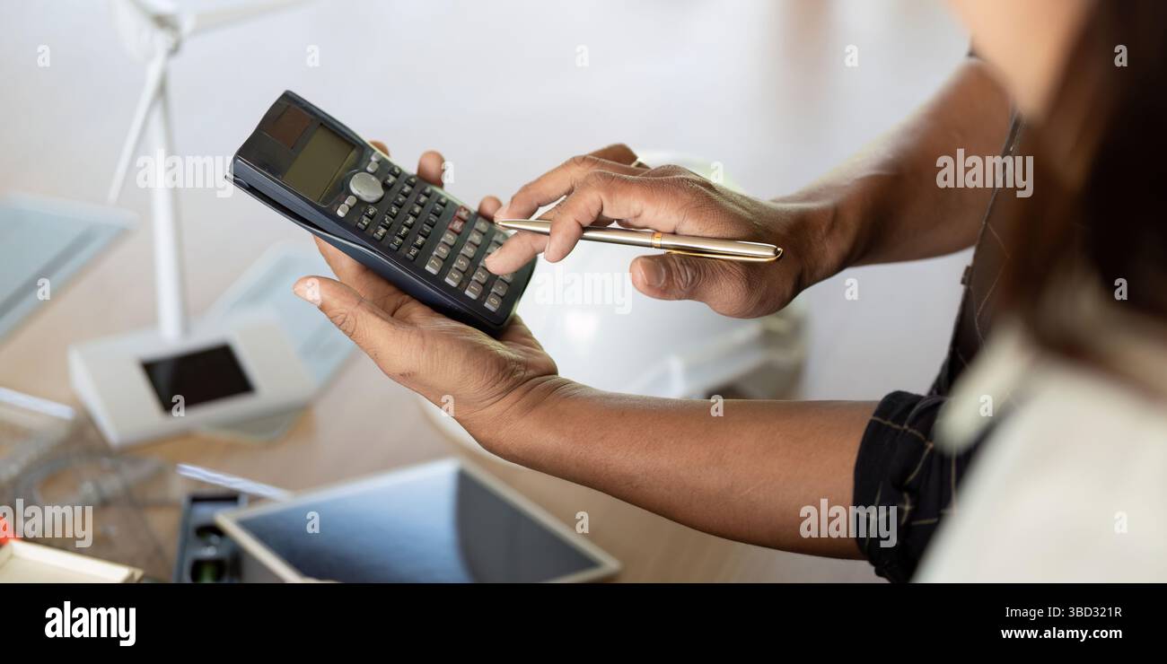 Sustainability and Engineering. Engineer using calculator for ...