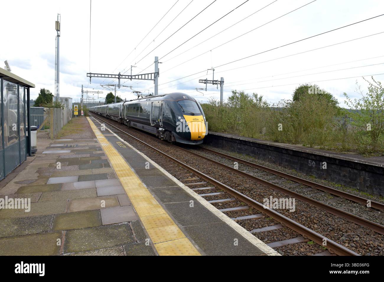 Great Western 800 Class Hitachi train passing through Pilning Railway Station, Bristol, UK, April 2025 Stock Photo