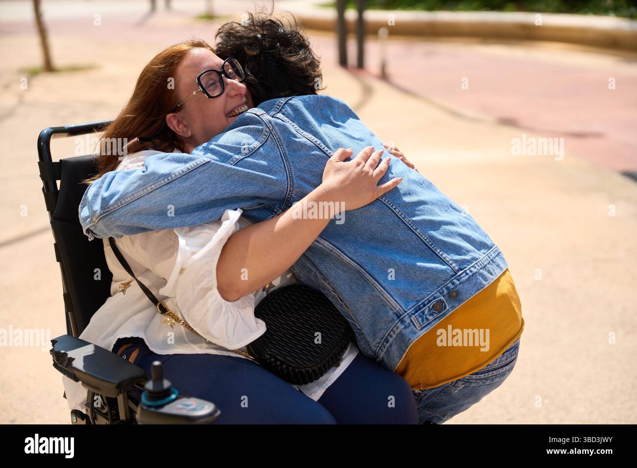 Heartfelt hug between friends in wheelchair - wheelchair and disability ...