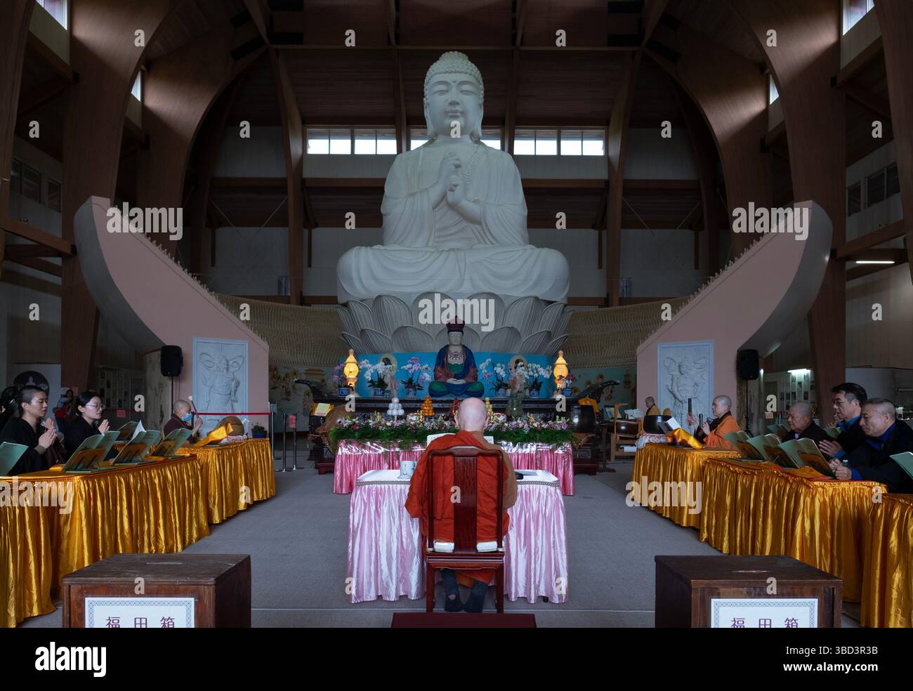A general view of the Buddah Hall at the Chuang Yen Monestary with a view of Bhikkhu Bodhi, the head priest. On Buddhah's birthday at a Vesaj service. Stock Photo