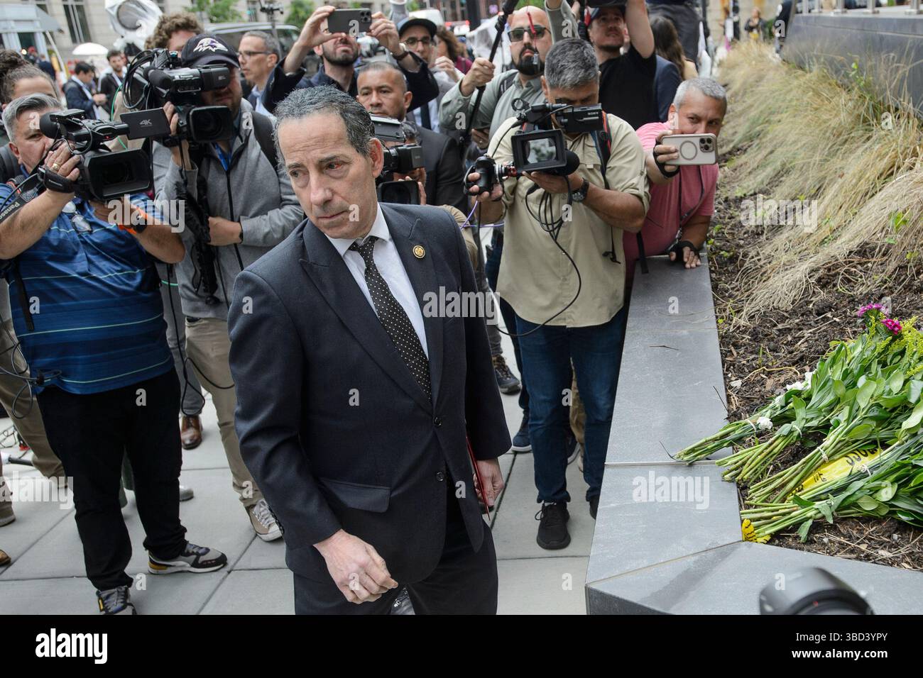 Rep. Jamie Raskin, D-Md., lays down flowers after two staff members of ...