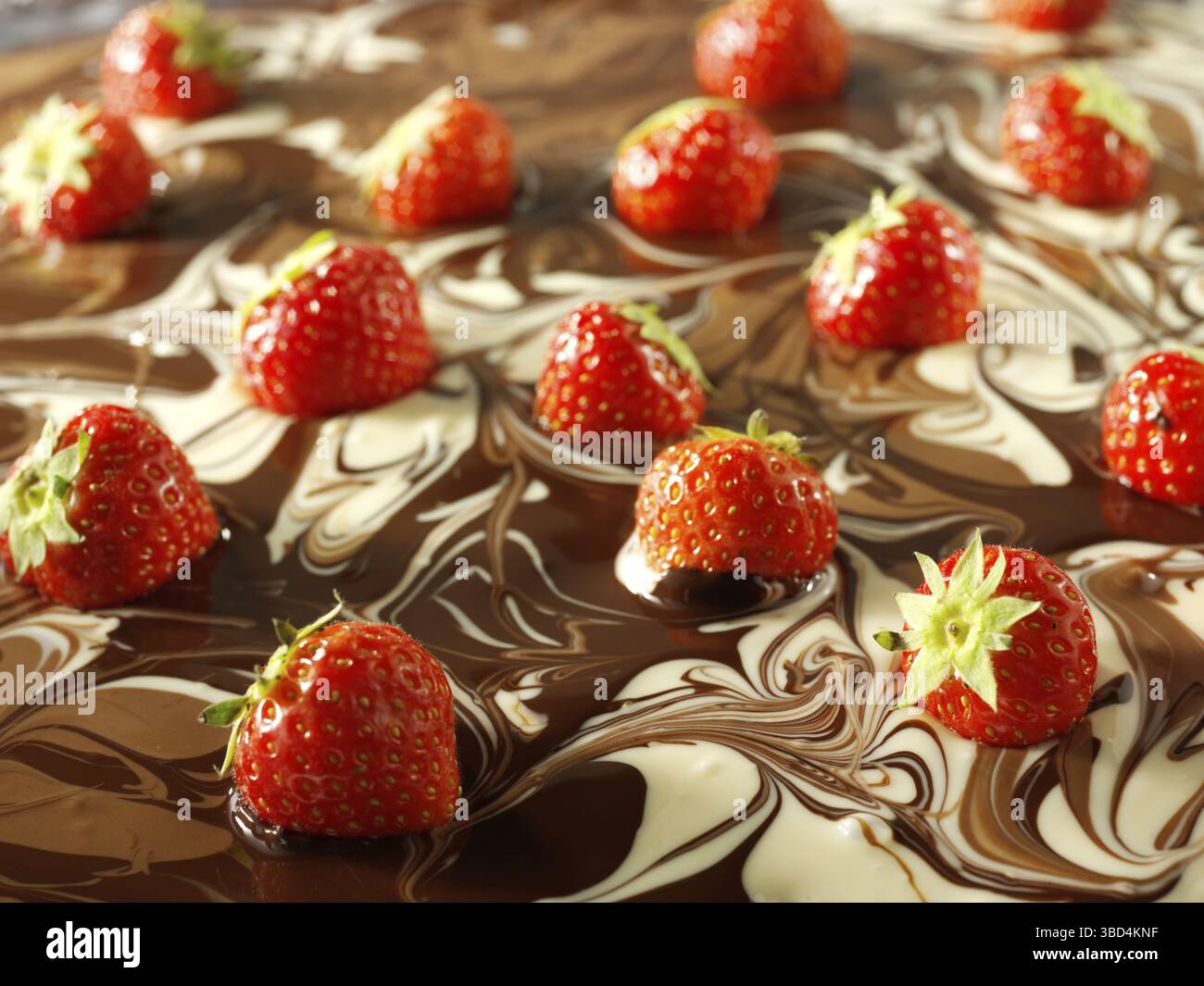 White and milk chocolate swirls with strawberries Stock Photo - Alamy
