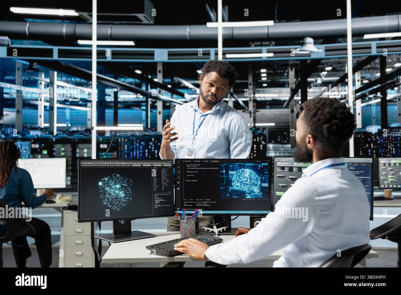 Data center manager supervising work done by engineer using deep ...