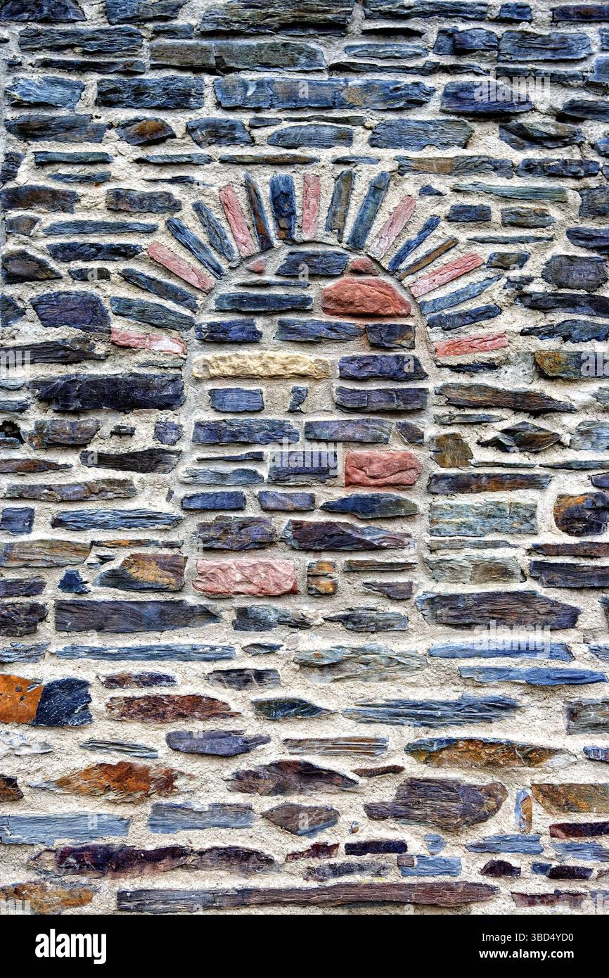 Natural stone wall with a bricked-up arch Stock Photo